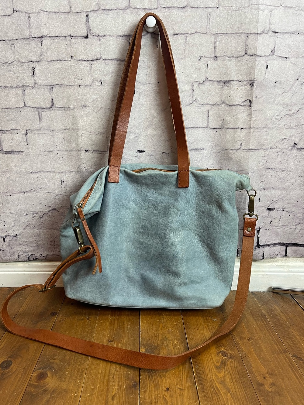 Blue leather zippered tote bag with brown straps